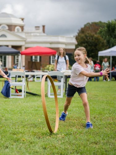 Children roll hoops on Monticello's West Lawn during Home Educator's Day