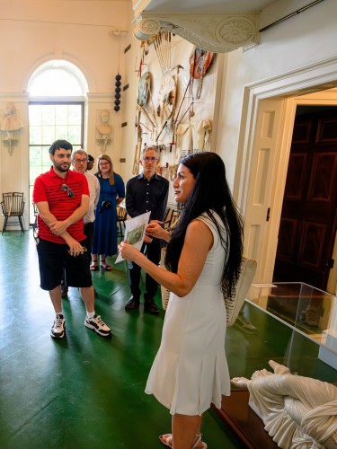 A guide talks with group of visitors in the Monticello Entrance Hall