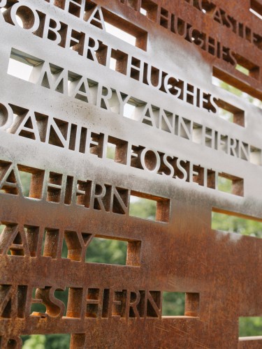 An iron-colored wall at the Contemplative Site at Monticello with names of all known workers enslaved by Thomas Jefferson, including those newly added