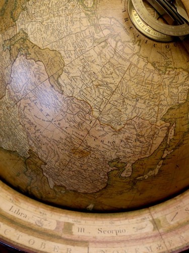 Historic globe of the world on a rotating stand.