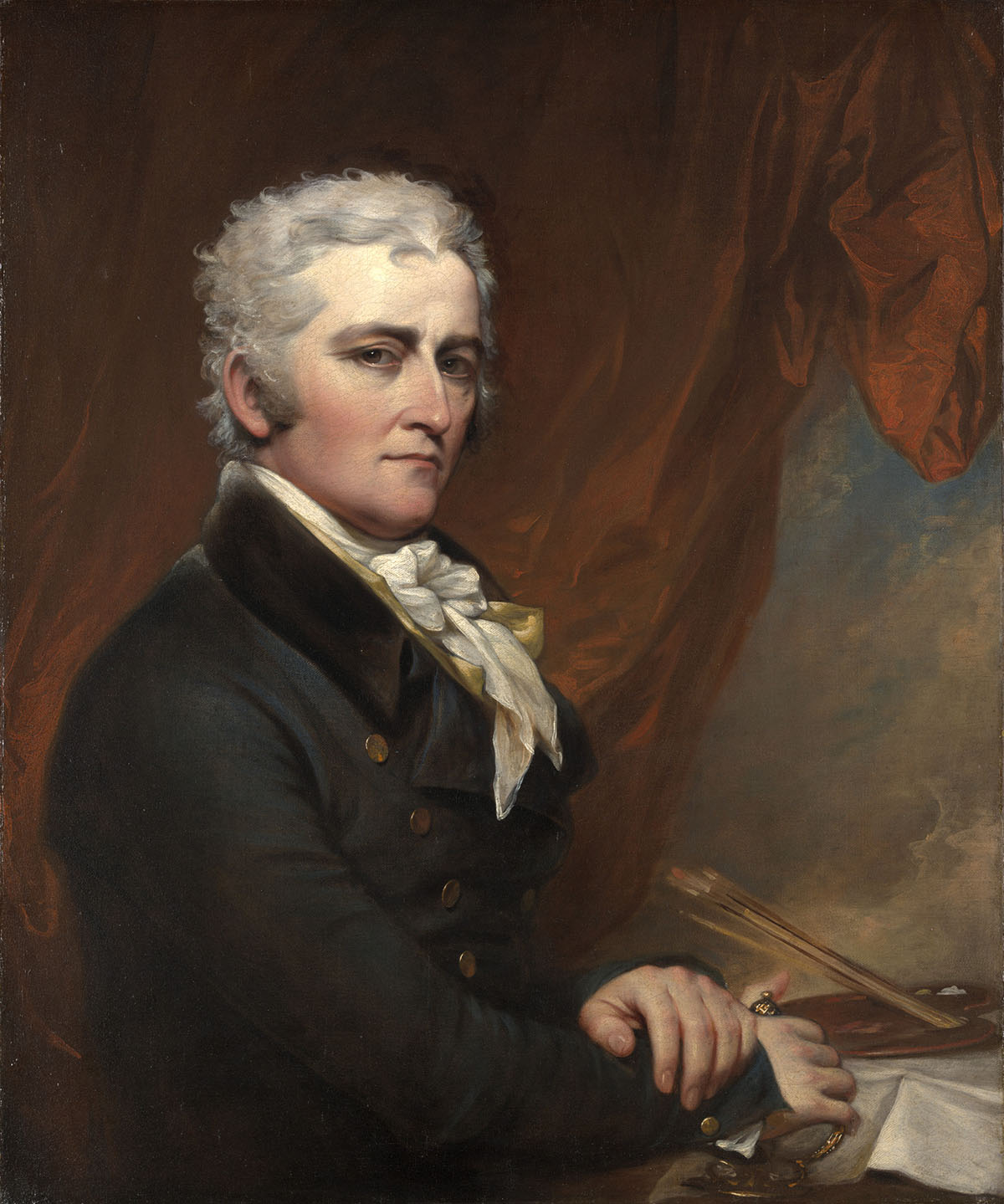 Painting of white man with dark eyes, graying short wavy hair wearting a thick-lapelled coat with a fine, white neckerchief and seated, hand crossed, at a table with painting supplies