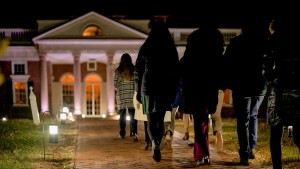 A group of people walking along a warmly lit path to take a holiday tour of Monticello, located near Charlottesville, VA in Albemarle County
