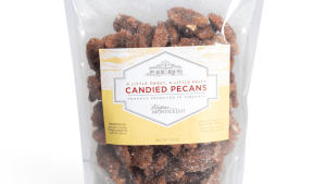 Pecans in a 10-ounce clear package with a white and light-yellow label showing an image of Monticello and the words " A Little Sweet, A  Little Salty / Candied Pecans /  Proudly Produced in Virginia"