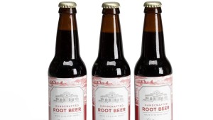 Three bottles of Monticello Root Beer and with red and white labels showing a drawing of Monticello and the words "Handcrafted / Monticello Root Beer / Made with Pure Honey"