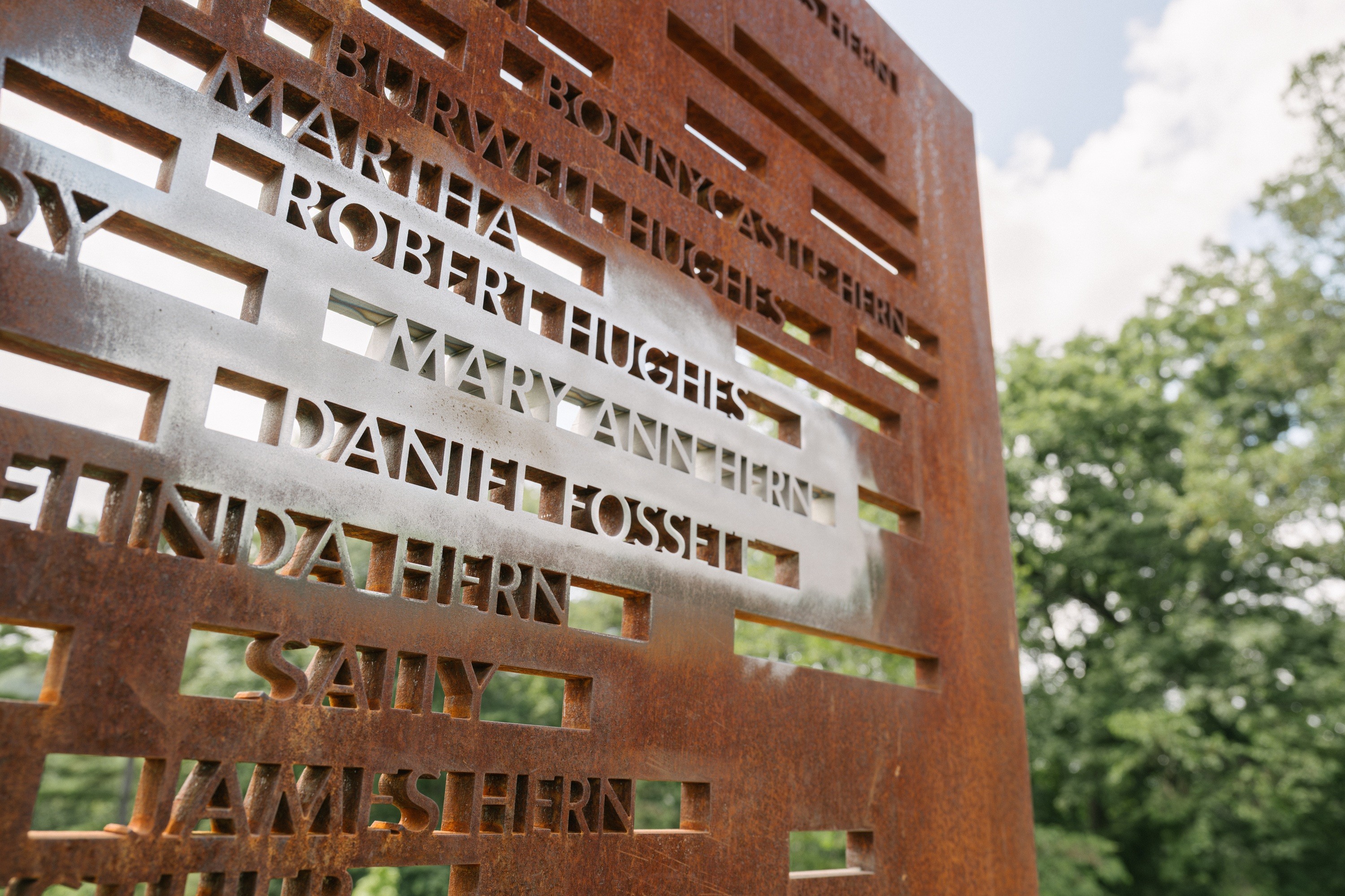 An iron-colored wall at the Contemplative Site at Monticello with names of all known workers enslaved by Thomas Jefferson, including those newly added