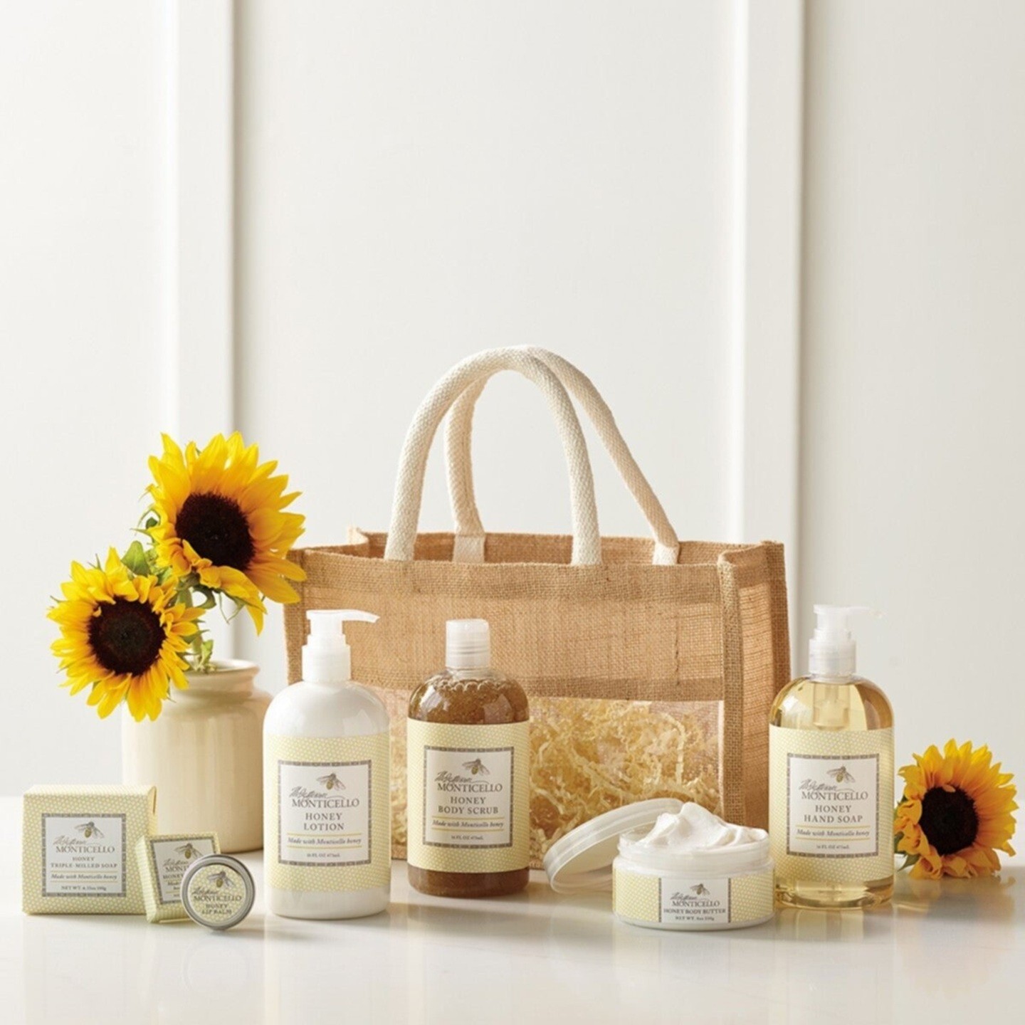 Bottles of skin care products arranged by fabric gift bag