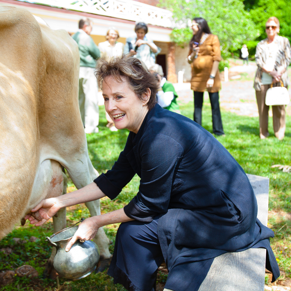 Chef Alice Waters milks a cow at Monticello